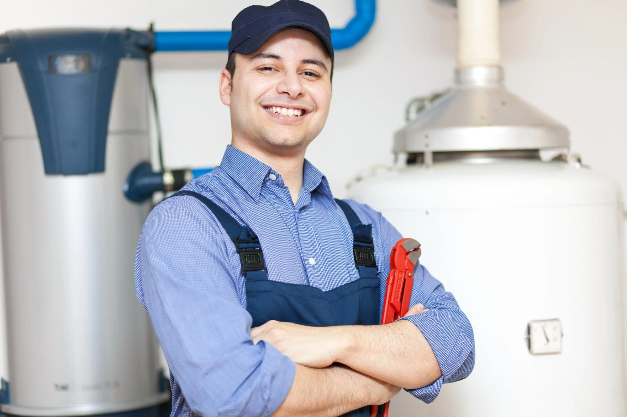 Plumber With Water Heater On The Background